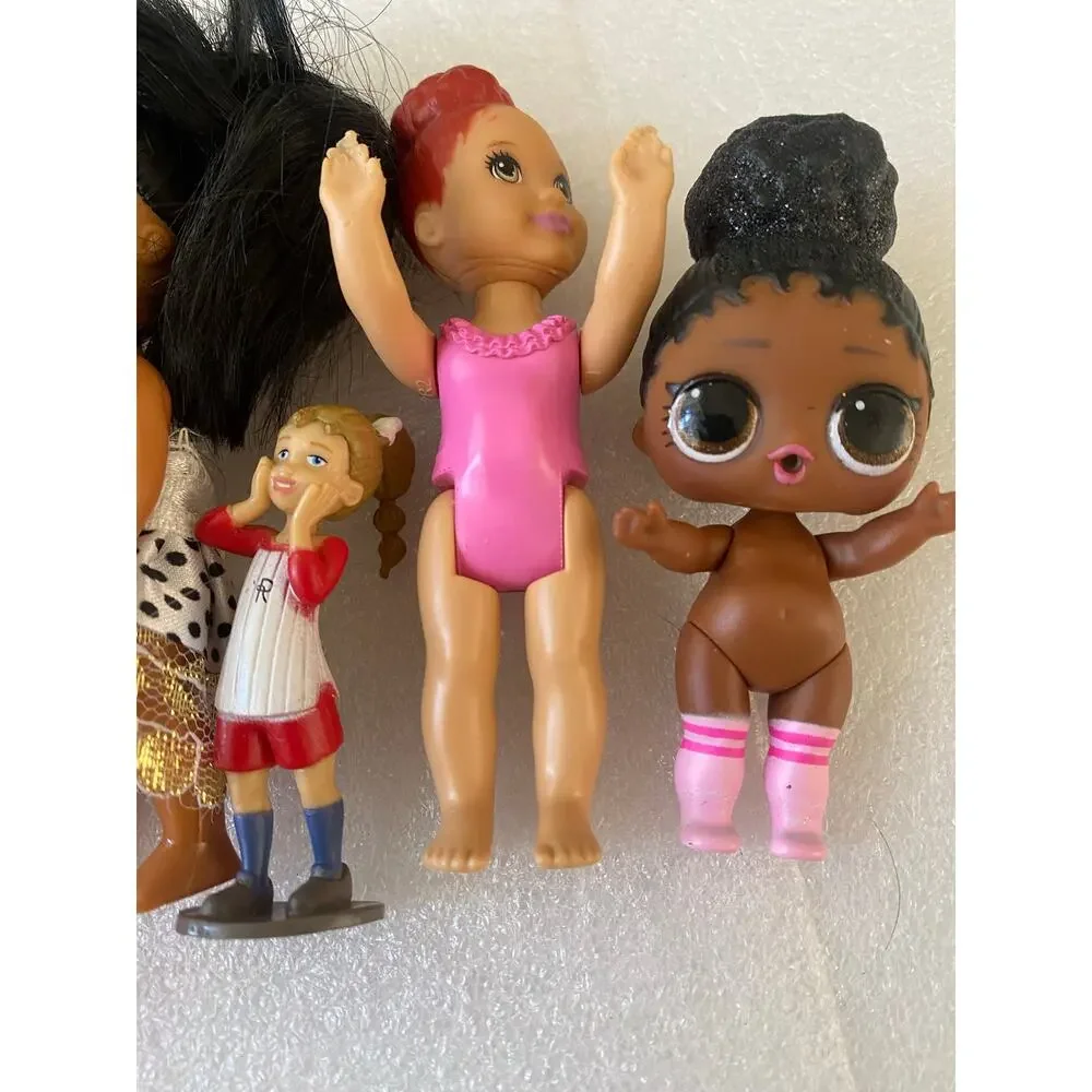 group of small Barbie Club Chelsea dolls and miniature figures in mixed outfits